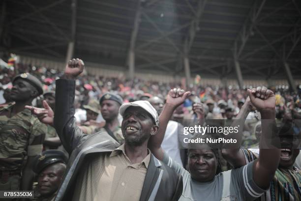 People react as Zimbabwean new President Emmerson Mnangagwa is officially sworn-in during a ceremony in Harare on November 24, 2017. Emmerson...