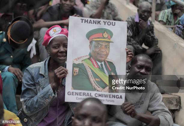 People react as Zimbabwean new President Emmerson Mnangagwa is officially sworn-in during a ceremony in Harare on November 24, 2017. Emmerson...