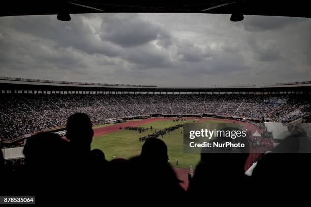 People react as Zimbabwean new President Emmerson Mnangagwa is officially sworn-in during a ceremony in Harare on November 24, 2017. Emmerson...