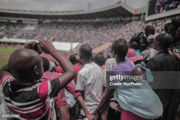 Child sleeping on his mother's back during the inauguration ceremony of Zimbabwe's new president Emmerson Mnangagwa at the Harare International...