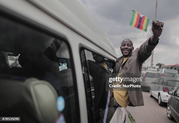 People react as Zimbabwean new President Emmerson Mnangagwa is officially sworn-in during a ceremony in Harare on November 24, 2017. Emmerson...