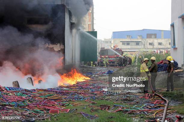 Firefighters try to douse a fire that broke out in a footwear factory at a residential area in Kolkata, India, November 24, 2017.