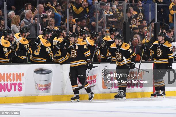 David Krejci, Jake DeBrusk and Peter Cehlarik of the Boston Bruins celebrate a goal in the first period against the Pittsburgh Penguins at the TD...