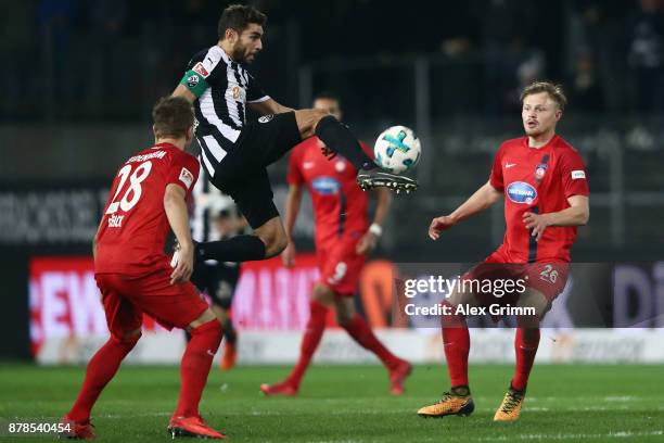 Nejmeddin Daghfous of Sandhausen controls the ball ahead of Arne Feick and Marcel Titsch-Rivero of Heidenheim during the Second Bundesliga match...