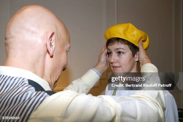 Stephen Jones, hat designer for Christian Dior fashion house, poses with Catherinette during Dior celebrates Sainte-Catherine at Dior Boutique on...