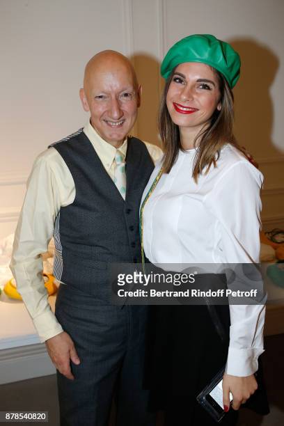 Stephen Jones, hat designer for Christian Dior fashion house, poses with a Catherinette during Dior celebrates Sainte-Catherine at Dior Boutique on...