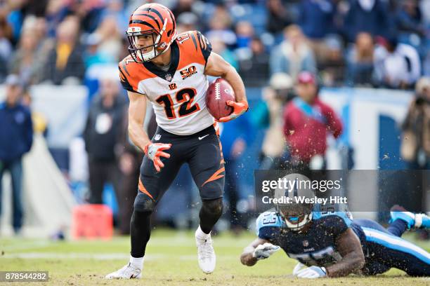 Alex Erickson of the Cincinnati Bengals runs the ball and avoids the tackle of Daren Bates of the Tennessee Titans at Nissan Stadium on November 12,...