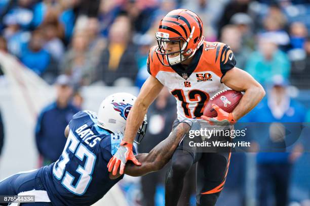 Alex Erickson of the Cincinnati Bengals runs the ball and avoids the tackle of Daren Bates of the Tennessee Titans at Nissan Stadium on November 12,...