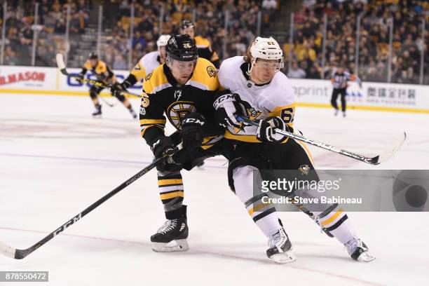 Brandon Carlo of the Boston Bruins against Carl Hagelin of the Pittsburgh Penguins at the TD Garden on November 24, 2017 in Boston, Massachusetts.