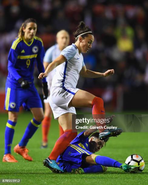 Lucy Bronze of England is tackled by Andela Seslija of Bosnia and Herzegovina during the FIFA Women's World Cup Qualifier between England and Bosnia...