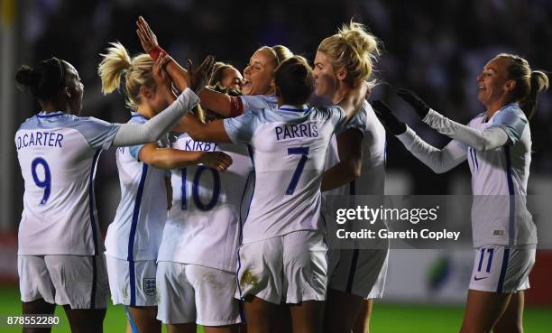 Steph Houghton of England celebrates as she scores their first goal with team mates during the FIFA Women's World Cup Qualifier between England and...