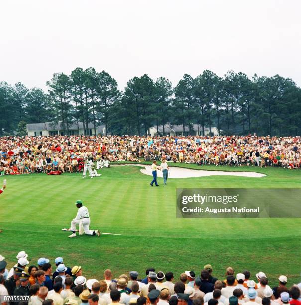 Masters Champion Bob Goalby shakes hands on the 18th green in front of a large gallery during the 1968 Masters Tournament at Augusta National Golf...