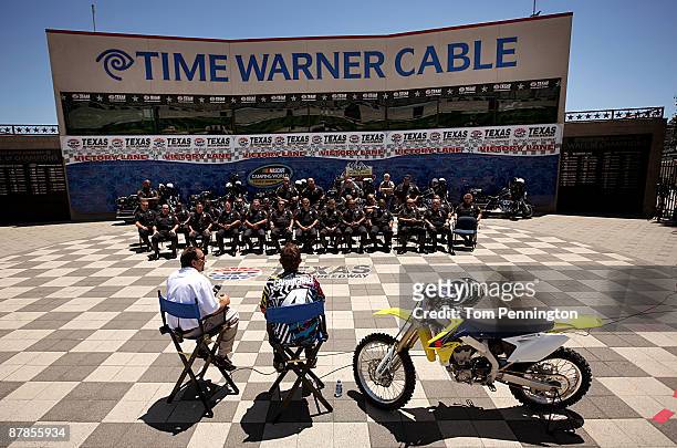 Camping World Truck Series driver Ricky Carmichael talks with officers of the Fort Worth Police Department Motorcycle Unit at Texas Motor Speedway...