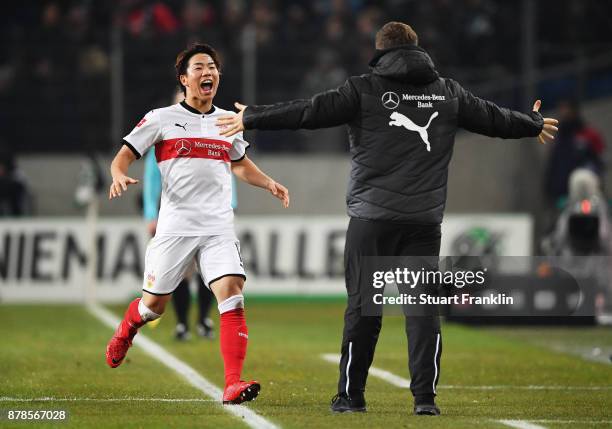 Takuma Asano of VfB Stuttgart is congratulated by Hannes Wolf head coach of VfB Stuttgart after scoring a goal during the Bundesliga match between...