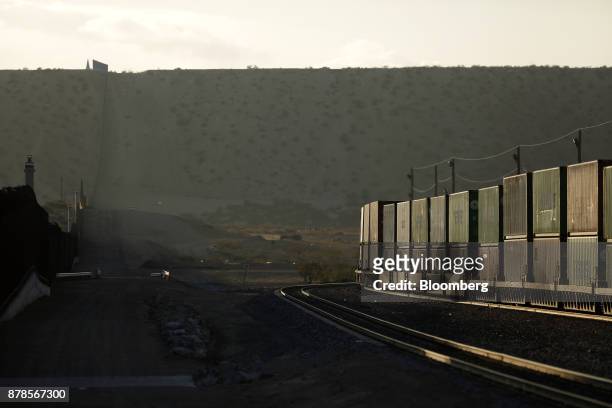 Union Pacific Corp. Freight train passes by a border fence that separates the U.S. And Mexico in Sunland Park, New Mexico, U.S., on Wednesday, Nov....