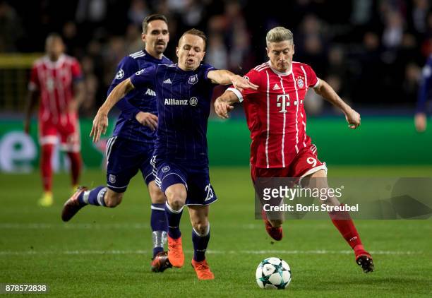 Robert Lewandowski of FC Bayern Muenchen is challenged by Adrien Trebel of Anderlecht during the UEFA Champions League group B match between RSC...