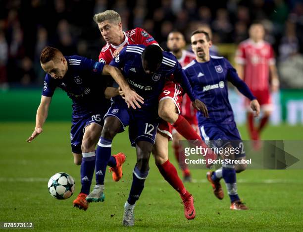 Robert Lewandowski of FC Bayern Muenchen is challenged by Adrien Trebel and Dennis Appiah of Anderlecht during the UEFA Champions League group B...