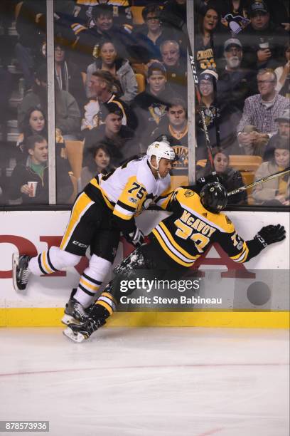 Ryan Reaves of the Pittsburgh Penguins checks against Charlie McAvoy of the Boston Bruins at the TD Garden on November 24, 2017 in Boston,...