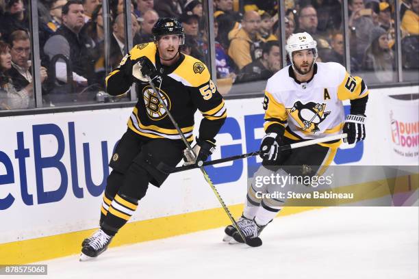 Tim Schaller of the Boston Bruins skates against Kris Letang of the Pittsburgh Penguins at the TD Garden on November 24, 2017 in Boston,...