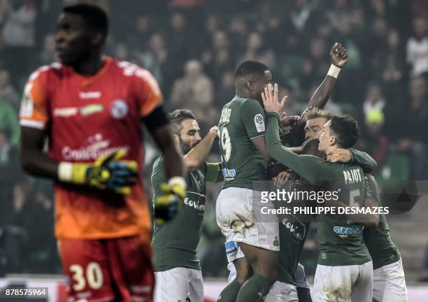 Strasbourg's French goalkeeper Bingourou Kamara looks on as Saint-Etienne's French forward Kevin Monnet-Paquet is congratulated by teammates after...