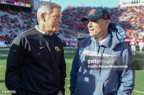 Head coach Kirk Ferentz of the Iowa Hawkeyes and head coach Mike Riley of the Nebraska Cornhuskers meet on the field before the game at Memorial...