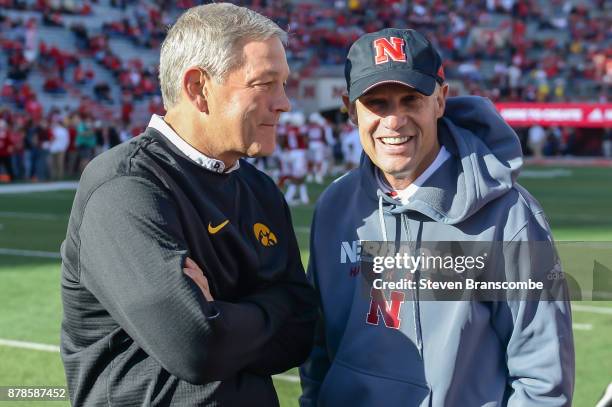 Head coach Kirk Ferentz of the Iowa Hawkeyes and head coach Mike Riley of the Nebraska Cornhuskers meet on the field before the game at Memorial...