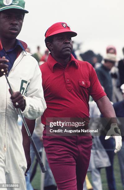 Lee Elder walks with his caddie during the 1975 Masters Tournament at Augusta National Golf Club on April 1975 in Augusta, Georgia.