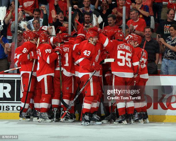 The Detroit Red Wings celebrate with their fans behind them after an overtime win in Game Two of the Western Conference Championship Round of the...