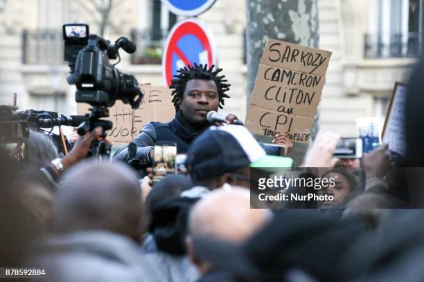 French rap singer Rost speaks outside the Embassy of Libya in Paris during a demonstration againts slavery in Libya on November 24, 2017.