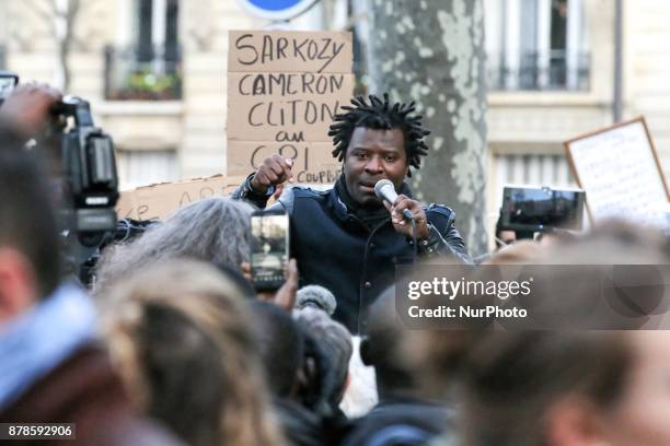 French rap singer Rost speaks outside the Embassy of Libya in Paris during a demonstration againts slavery in Libya on November 24, 2017.