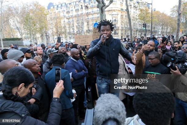 French rap singer Rost speaks outside the Embassy of Libya in Paris during a demonstration againts slavery in Libya on November 24, 2017.