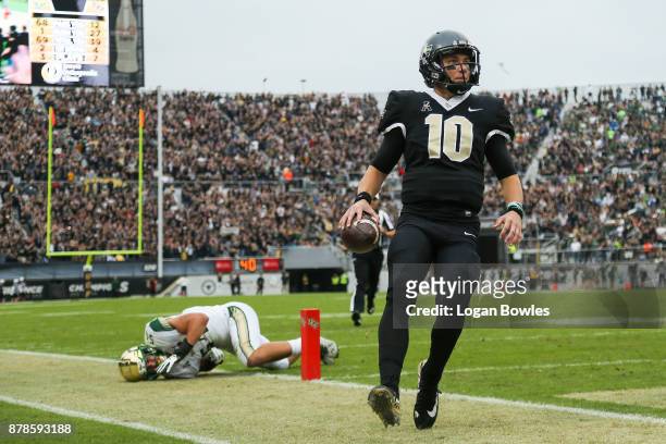 McKenzie Milton of the UCF Knights runs the ball for a touchdown in the first quarter against the South Florida Bulls at Spectrum Stadium on November...
