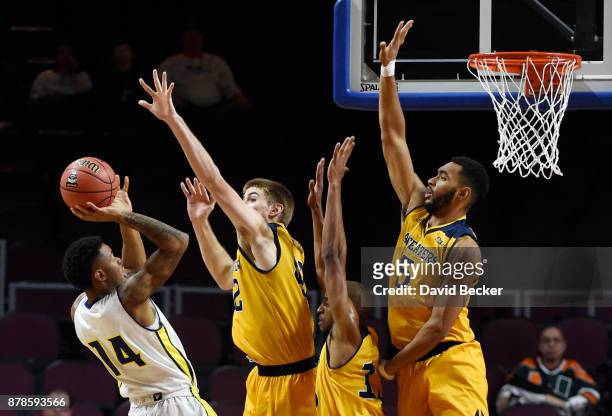 Karl Harris of the Northern Arizona Lumberjacks shoots against Tommy Rutherford, Brandon Smith and Jonathan Galloway of the UC Irvine Anteaters...