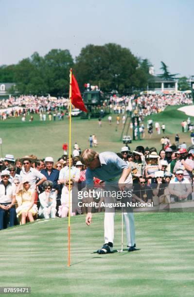 Johnny Miller retrieves his ball during the 1975 Masters Tournament at Augusta National Golf Club in April 1975 in Augusta, Georgia.