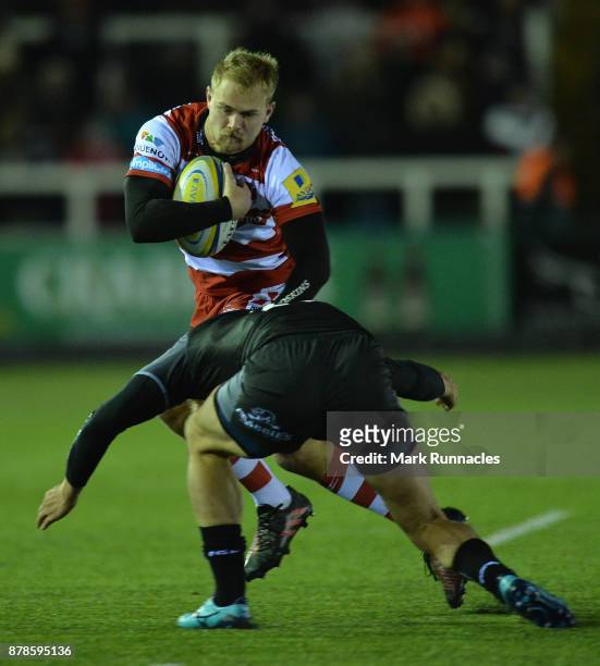 Jeremy Thrush of Gloucester Rugby is tackled by Mark Atkinson of Newcastle Falcons during the Aviva Premiership match between Newcastle Falcons and...