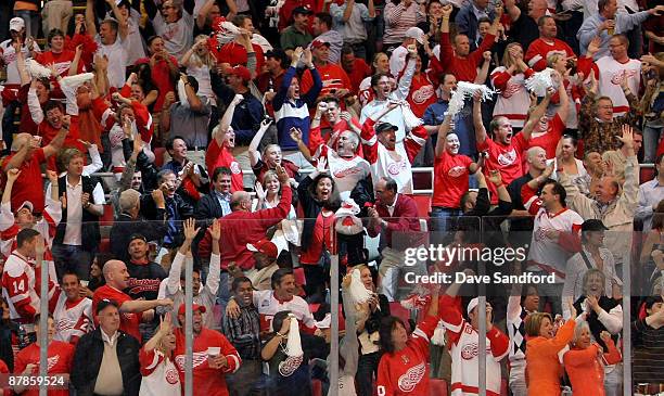 Fans of the Detroit Red Wings celebrate after they won 3-2 in overtime against the Chicago Blackhawks during Game Two of the Western Conference...
