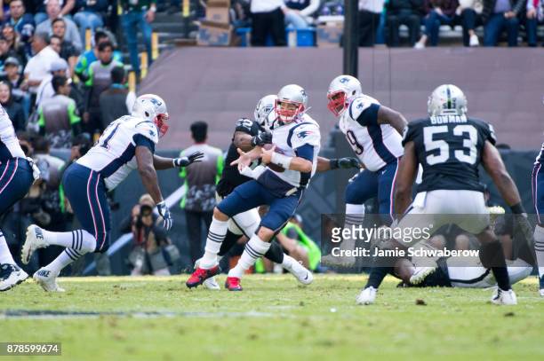 Quarterback Tom Brady of the New England Patriots is sacked by Khalil Mack of the Oakland Raiders at Estadio Azteca on November 19, 2017 in Mexico...