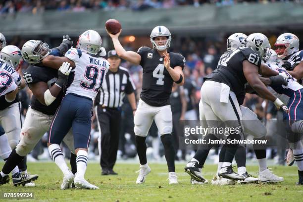 Quarterback Derek Carr of the Oakland Raiders passes against the New England Patriots at Estadio Azteca on November 19, 2017 in Mexico City, Mexico.