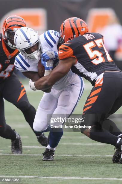 Marlon Mack of the Indianapolis Colts runs the football upfield against Vincent Rey of the Cincinnati Bengals during their game at Paul Brown Stadium...