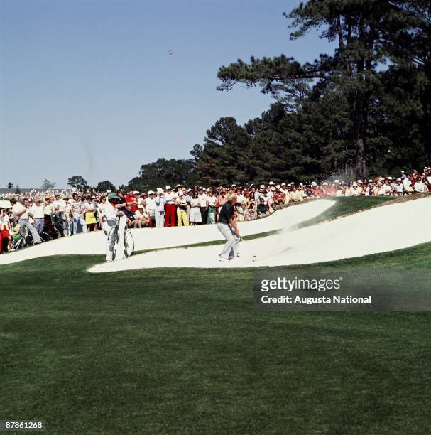 Johnny Miller shoots out of a bunker on the seventh hole during the 1977 Masters Tournament at Augusta National Golf Club in April 1977 in Augusta,...