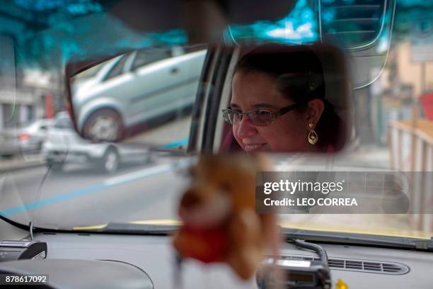 Taxi driver Vanessa Moura poses for the picture inside her cab in Rio de Janeiro, Brazil, on November 24, 2017. Moura -who has been working for two...