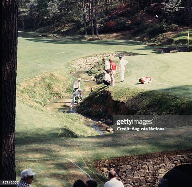 Gary Player studies his ball in the water hazard of the 13th hole during the 1978 Masters Tournament at Augusta National Golf Club on April 1978 in...
