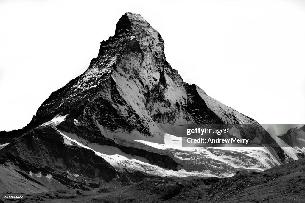 Matterhorn north face, snow capped, triangle shaped, high-contrast black and white.