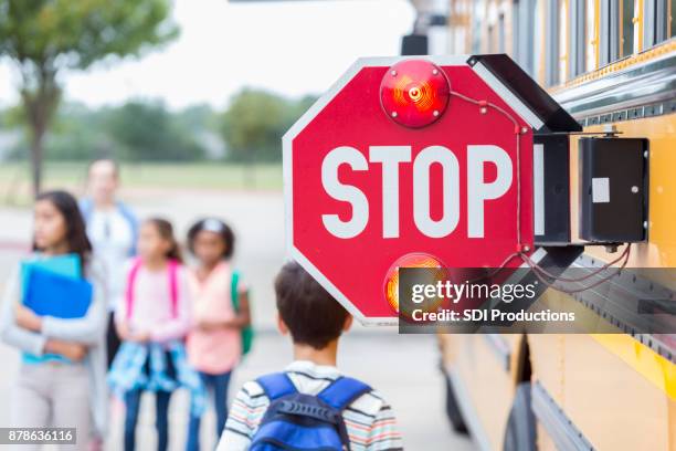 close up of stop sign on school bus - bus sign stock pictures, royalty-free photos & images