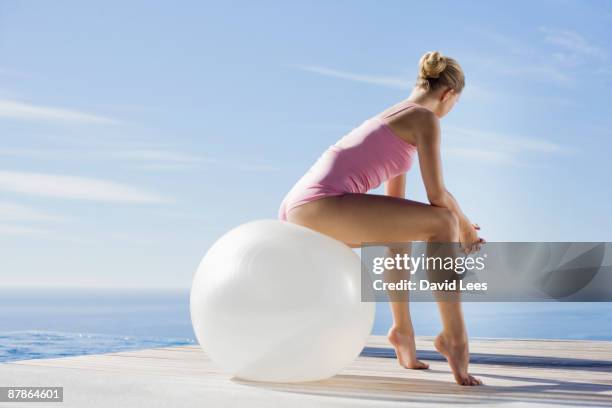 young woman exercising with fitness ball - gymnastikball stock-fotos und bilder