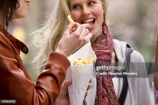 dutch amsterdam girls eating fries - french fries bildbanksfoton och bilder