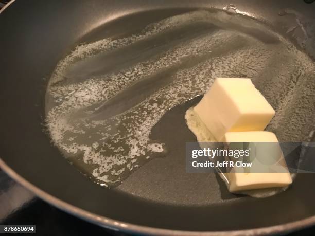 melted butter in a fry pan at home closeup - melting pot foto e immagini stock