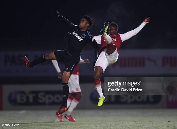Tolaji Bola of Arsenal is challenged by Jahmal Hector-Ingram of West Ham during the Premier League Two match between Arsenal U23 and West Ham United...