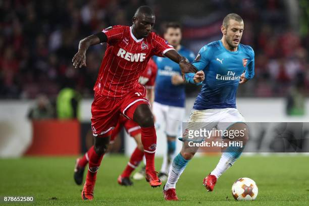 Jack Wilshere of Arsenal and Sehrou Guirassy of Koeln battle for the ball during the UEFA Europa League group H match between 1. FC Koeln and Arsenal...