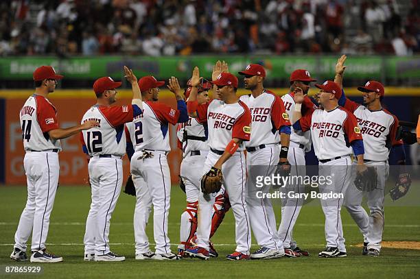 The Puerto Rico team celebrates after their win against Panama during the Pool D, game two between the Puerto Rico and Panama during the the first...